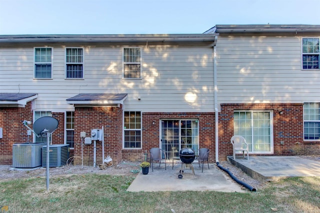 back of property with central AC and a patio area