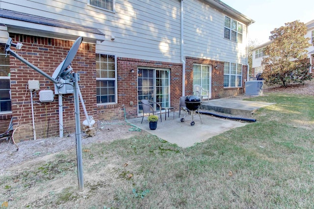 rear view of property featuring a patio area and a lawn