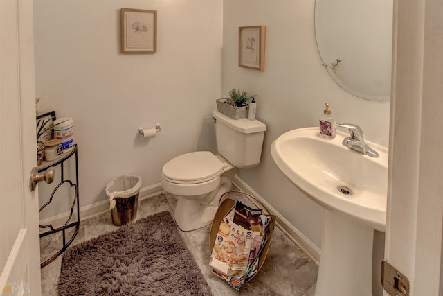 bathroom with toilet and tile floors