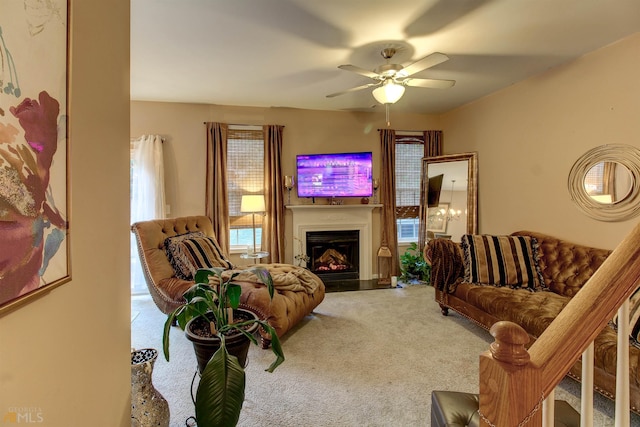 carpeted living room featuring ceiling fan