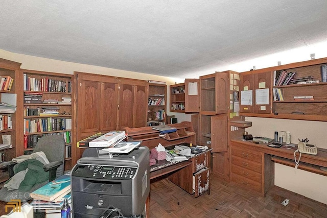 office space featuring dark parquet floors and a textured ceiling