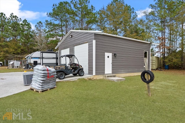 view of shed / structure featuring central AC, a garage, and a yard