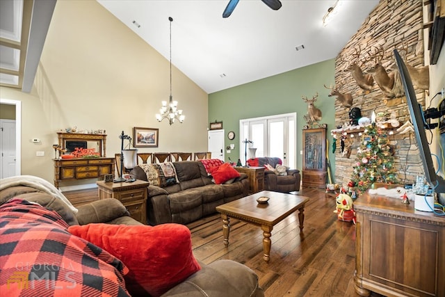 living room with high vaulted ceiling, ceiling fan with notable chandelier, and dark hardwood / wood-style flooring