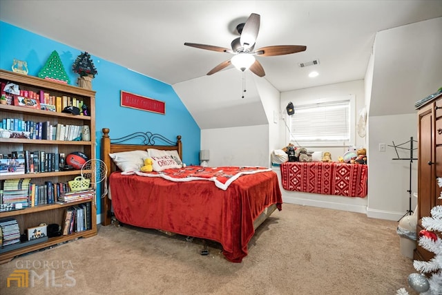 carpeted bedroom with vaulted ceiling and ceiling fan