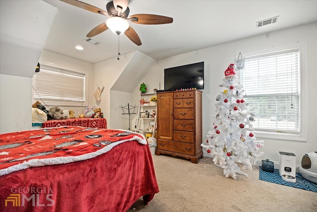carpeted bedroom with lofted ceiling, ceiling fan, and multiple windows