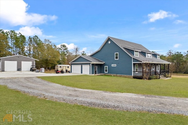 view of front of home featuring a porch, an outdoor structure, a front yard, and a garage