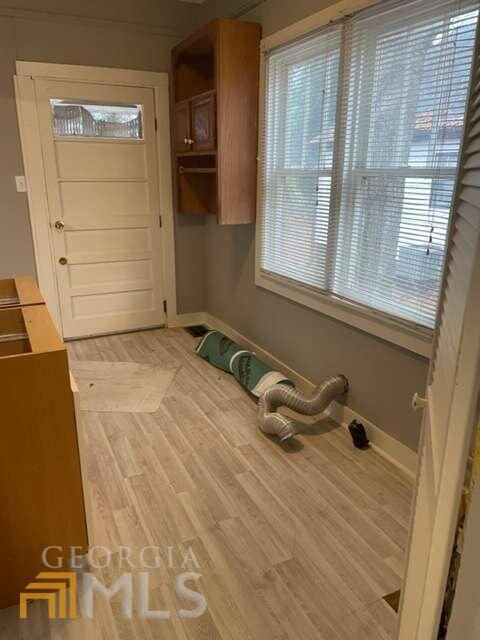 interior space featuring light hardwood / wood-style flooring, cabinets, and a healthy amount of sunlight