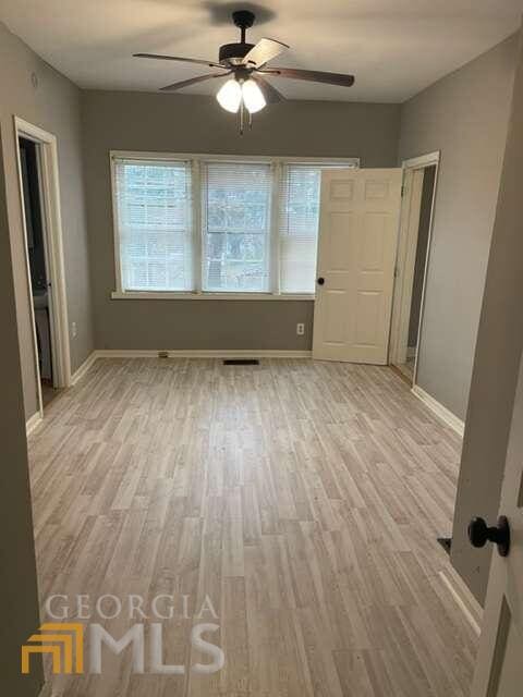 spare room featuring ceiling fan and light wood-type flooring