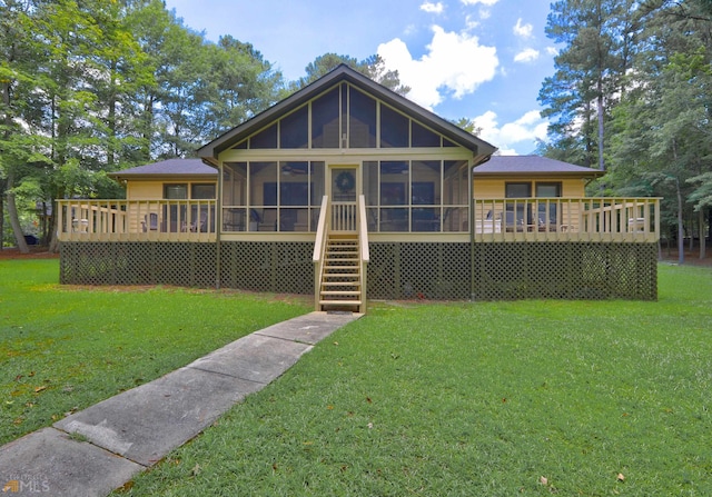 back of house with a deck, a sunroom, and a yard