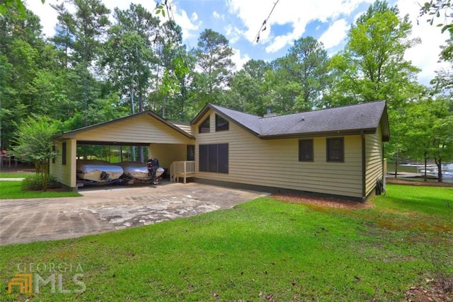 ranch-style home with a carport and a front lawn