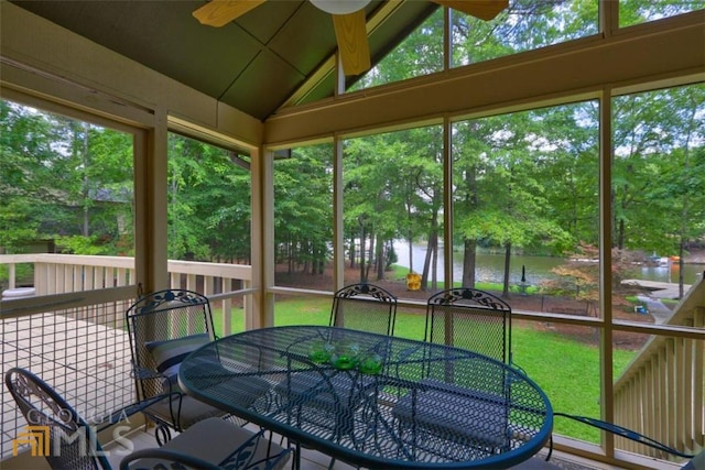 sunroom / solarium with lofted ceiling, a water view, ceiling fan, and plenty of natural light