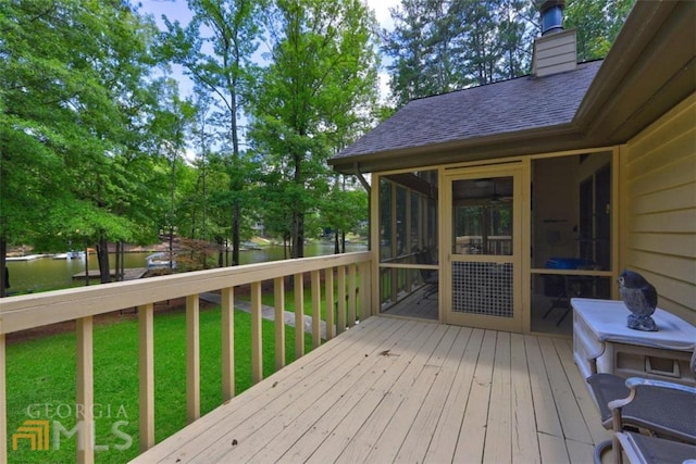 wooden terrace featuring a yard