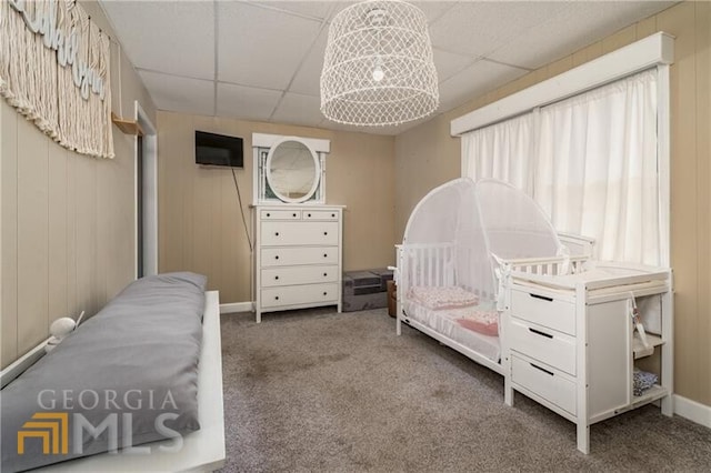 carpeted bedroom featuring a drop ceiling