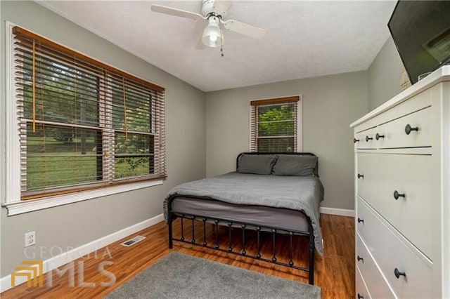 bedroom featuring dark hardwood / wood-style flooring and ceiling fan