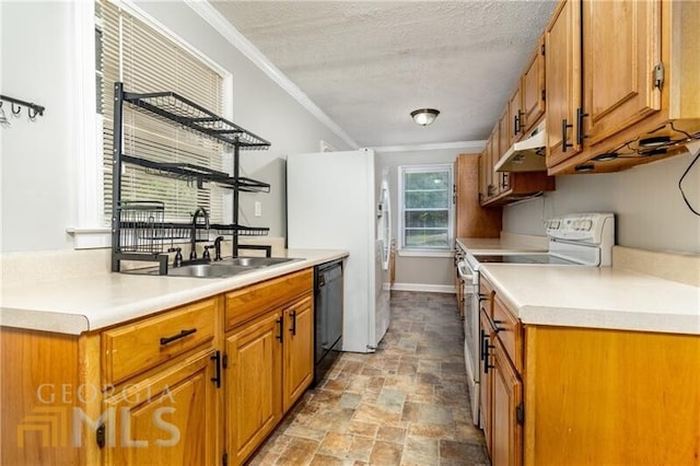 kitchen with white appliances, sink, light tile floors, ornamental molding, and a textured ceiling