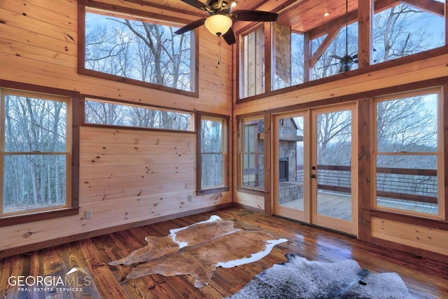 unfurnished sunroom with ceiling fan