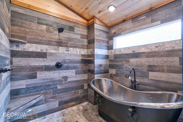 bathroom featuring a bathing tub, wooden ceiling, and vaulted ceiling