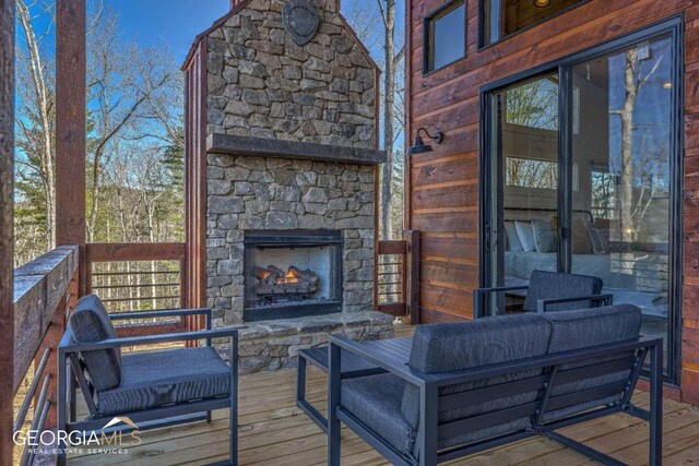 wooden deck featuring an outdoor living space with a fireplace