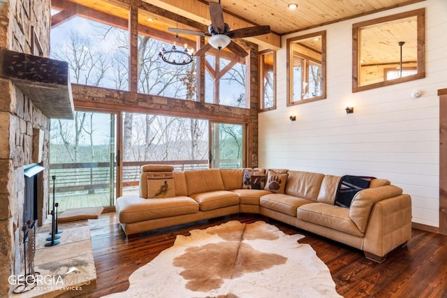 living room with high vaulted ceiling, dark hardwood / wood-style flooring, ceiling fan with notable chandelier, and wood ceiling