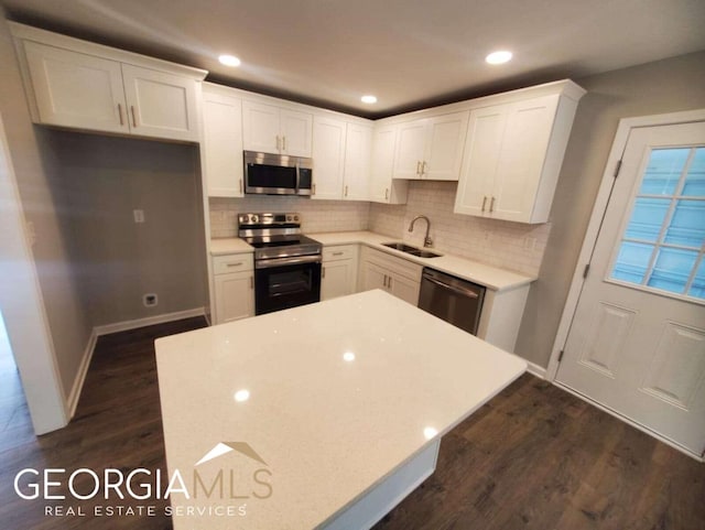 kitchen featuring white cabinetry, appliances with stainless steel finishes, and dark hardwood / wood-style flooring