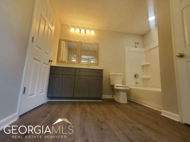 full bathroom featuring toilet, vanity, wood-type flooring, and tub / shower combination