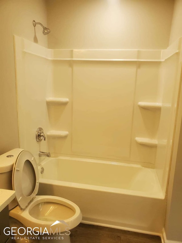 full bathroom featuring vanity, hardwood / wood-style floors, toilet, and bathing tub / shower combination