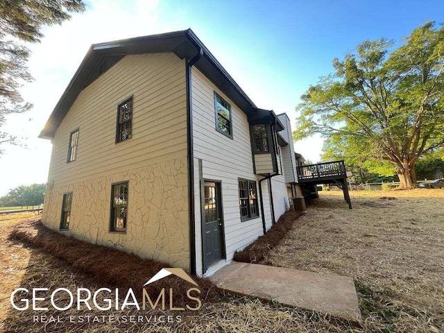 view of property exterior featuring a deck