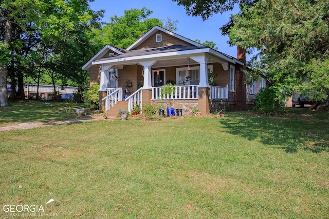 bungalow-style home with a porch and a front yard