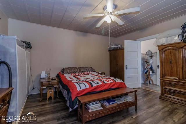 bedroom with ceiling fan and dark hardwood / wood-style floors