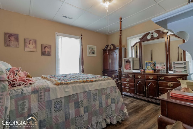 bedroom with dark hardwood / wood-style flooring