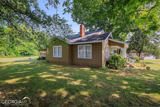 view of property exterior with a yard and covered porch