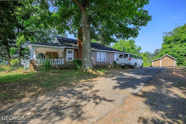 view of front of home with a porch, an outdoor structure, and a garage