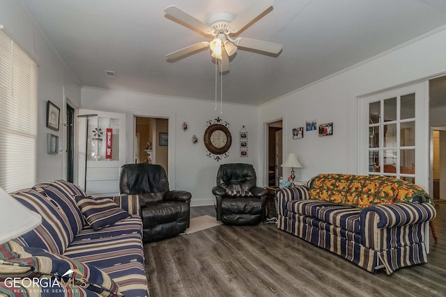 living room with dark hardwood / wood-style floors, ceiling fan, and ornamental molding