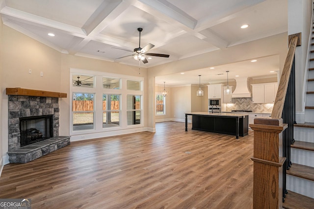 101 Bonnie Lynn Ln, Carrollton, GA 30117 - living room with ceiling fan with notable chandelier, wood finished floors, a fireplace, and stairs