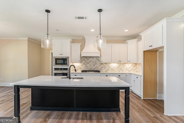 101 Bonnie Lynn Ln, Carrollton, GA 30117 - kitchen featuring visible vents, black appliances, a sink, premium range hood, and backsplash