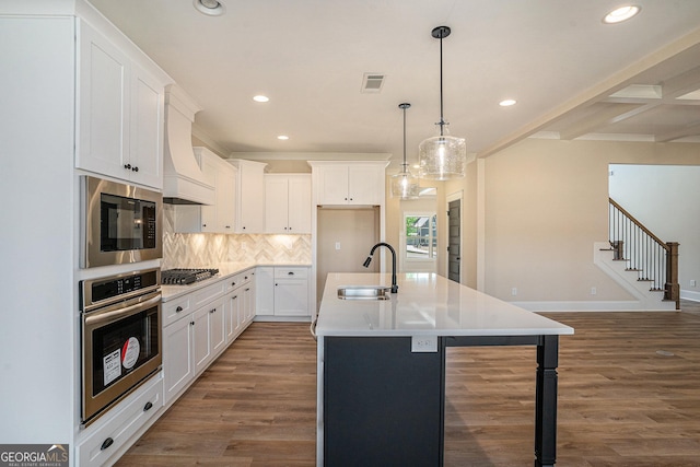 101 Bonnie Lynn Ln, Carrollton, GA 30117 - kitchen featuring tasteful backsplash, visible vents, wood finished floors, a sink, and stainless steel appliances