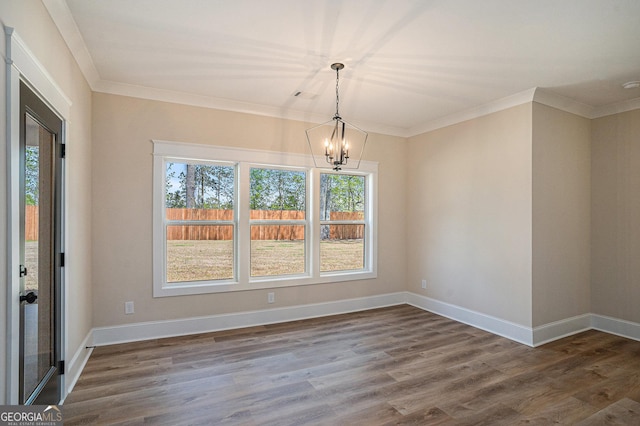 101 Bonnie Lynn Ln, Carrollton, GA 30117 - unfurnished dining area featuring crown molding, baseboards, a notable chandelier, and dark wood finished floors
