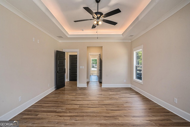 101 Bonnie Lynn Ln, Carrollton, GA 30117 - unfurnished bedroom with a ceiling fan, visible vents, a raised ceiling, baseboards, and dark wood-style floors