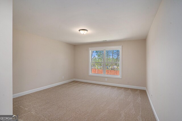 101 Bonnie Lynn Ln, Carrollton, GA 30117 - empty room featuring light colored carpet, baseboards, and visible vents