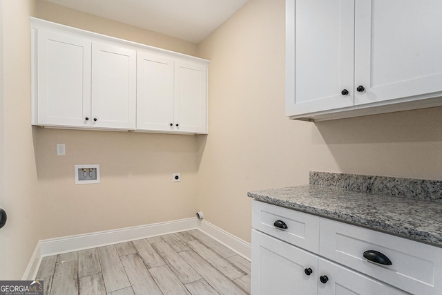101 Bonnie Lynn Ln, Carrollton, GA 30117 - laundry room featuring electric dryer hookup, light wood-type flooring, washer hookup, baseboards, and cabinet space