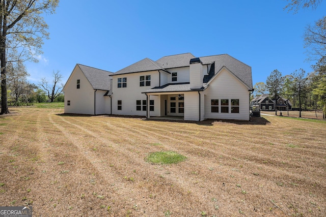 101 Bonnie Lynn Ln, Carrollton, GA 30117 - rear view of house with a patio area, roof with shingles, and a lawn