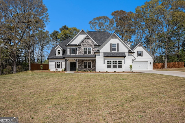 101 Bonnie Lynn Ln, Carrollton, GA 30117 - view of front of house featuring a front yard, an attached garage, stone siding, fence, and concrete driveway