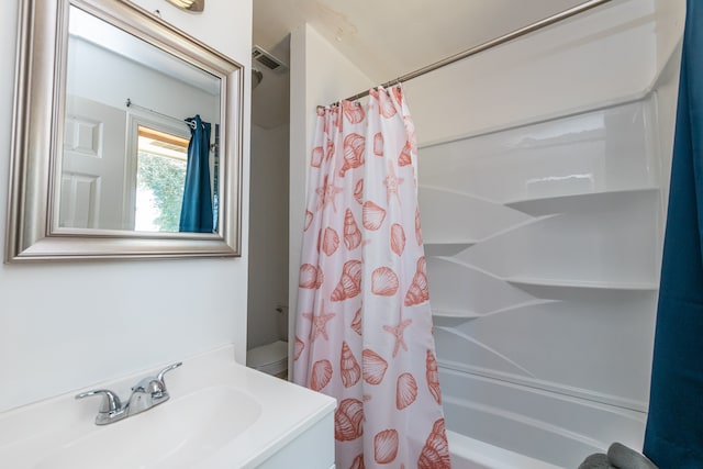 full bathroom with toilet, oversized vanity, and shower / tub combo