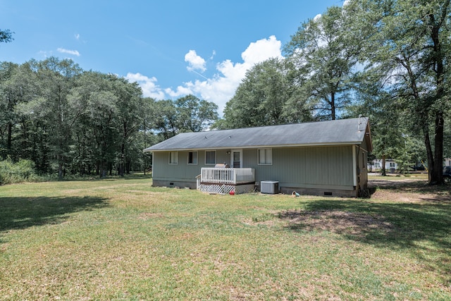 back of house featuring a lawn and central AC unit