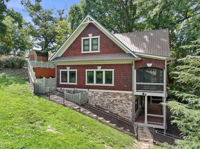 view of home's exterior with a sunroom and a yard