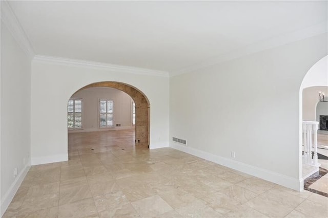 tiled empty room featuring crown molding