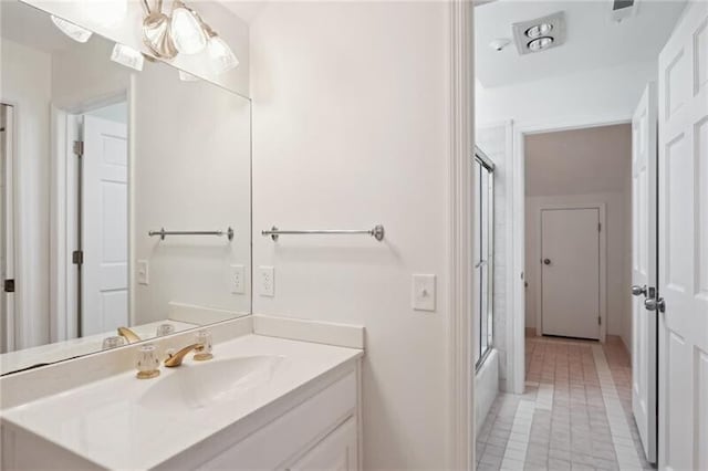 bathroom with shower / bath combination with glass door, vanity, and tile flooring