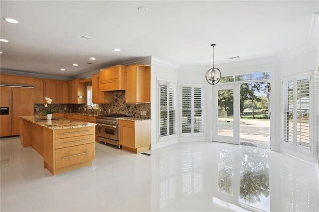 kitchen featuring tasteful backsplash, light tile floors, premium appliances, light stone countertops, and pendant lighting