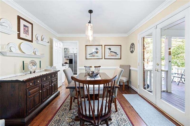 dining space featuring french doors, dark hardwood / wood-style floors, and ornamental molding