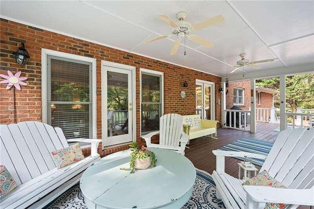 wooden terrace featuring ceiling fan and covered porch